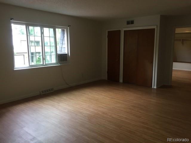 2703 Stanford Road Fort Collins, CO 80525 - Photo 15 of 30 an empty room with wooden floor and windows