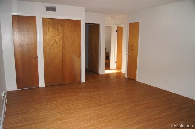 2703 Stanford Road Fort Collins, CO 80525 - Photo 17 of 30 a view of an empty room with wooden floor and closet