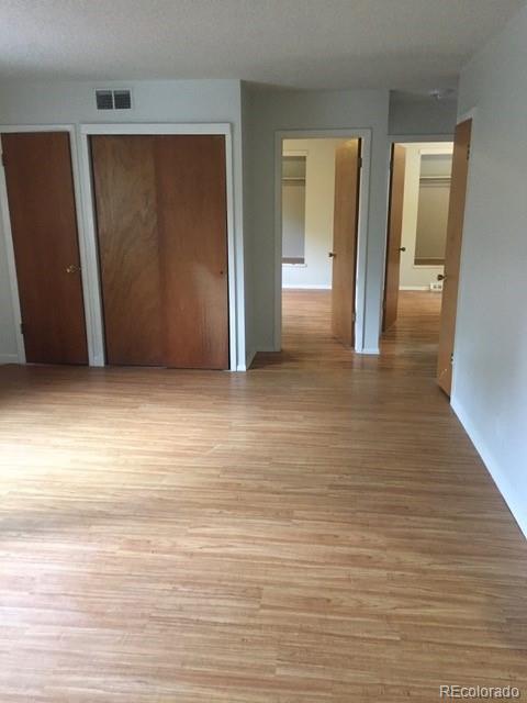 2703 Stanford Road Fort Collins, CO 80525 - Photo 18 of 30 an empty room with wooden floor and closet
