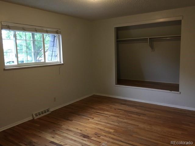 2703 Stanford Road Fort Collins, CO 80525 - Photo 19 of 30 an empty room with wooden floor and windows