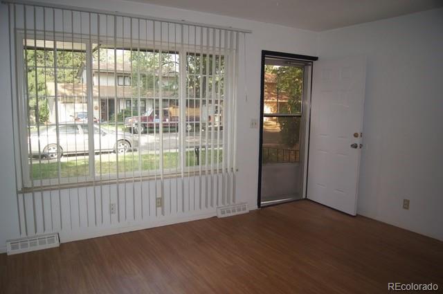 2703 Stanford Road Fort Collins, CO 80525 - Photo 22 of 30 an empty room with wooden floor and windows
