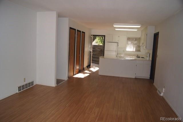 2703 Stanford Road Fort Collins, CO 80525 - Photo 23 of 30 an empty room with wooden floor and windows