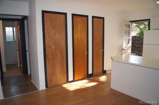 2703 Stanford Road Fort Collins, CO 80525 - Photo 25 of 30 a view of a hallway with wooden floor and a bathroom