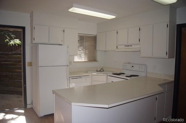 2703 Stanford Road Fort Collins, CO 80525 - Photo 26 of 30 a kitchen with a sink a refrigerator and white cabinets
