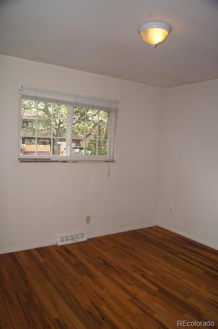 2703 Stanford Road Fort Collins, CO 80525 - Photo 27 of 30 an empty room with wooden floor and windows