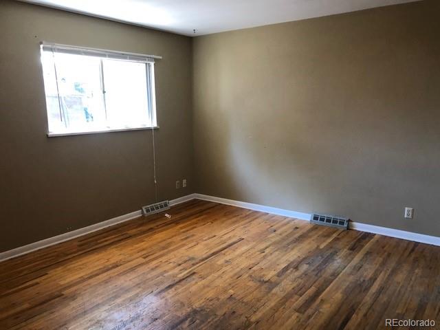 2703 Stanford Road Fort Collins, CO 80525 - Photo 6 of 30 an empty room with wooden floor and windows