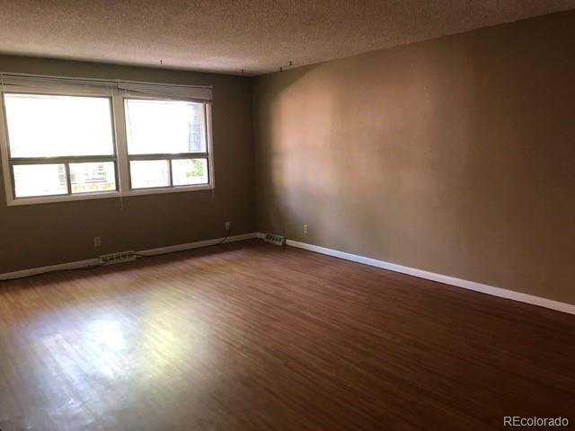 2703 Stanford Road Fort Collins, CO 80525 - Photo 8 of 30 an empty room with wooden floor and windows