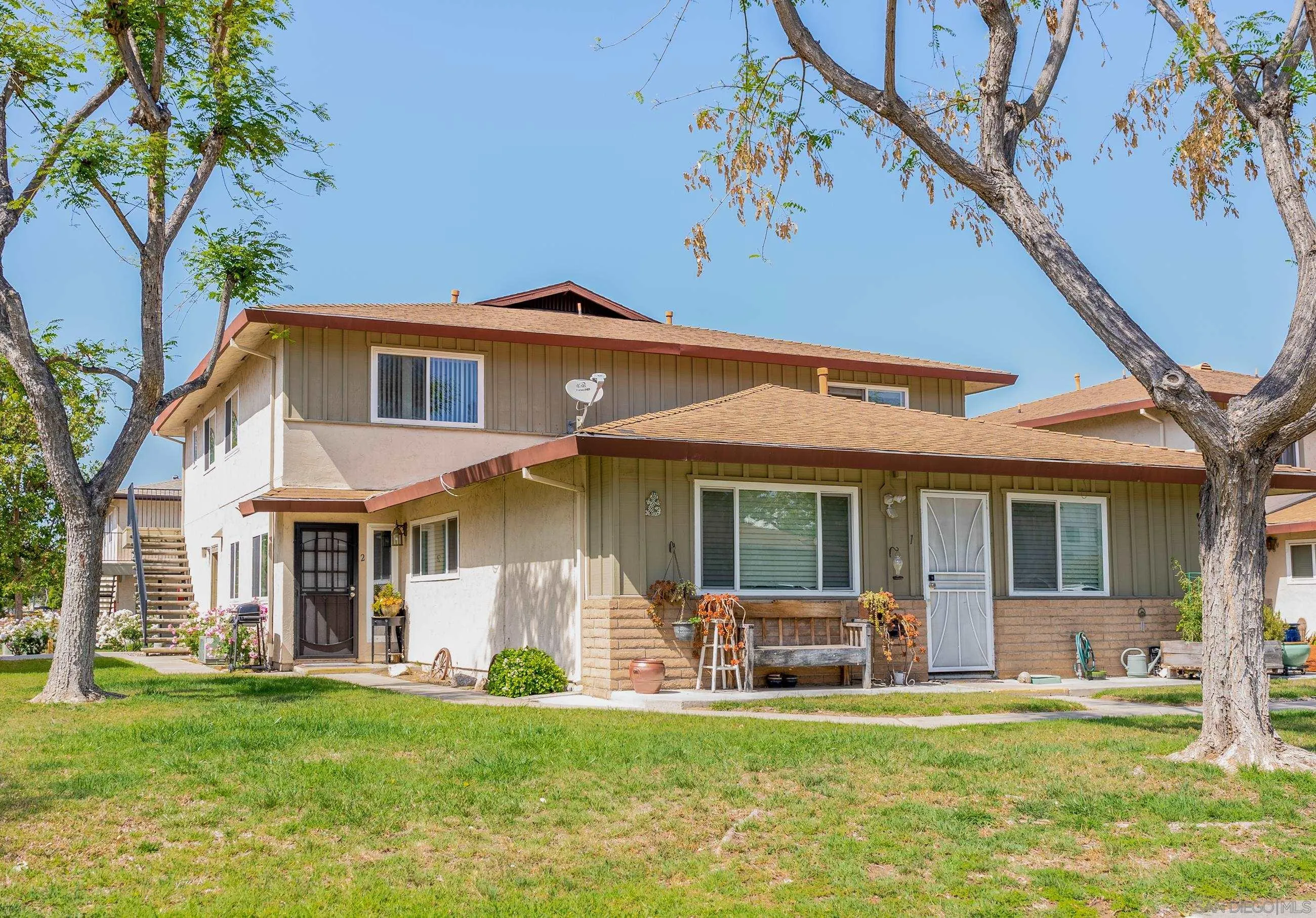 9920 Mission Vega Road, Unit 2 Santee, CA 92071 - Photo 3 of 21 a front view of a house with a garden and porch