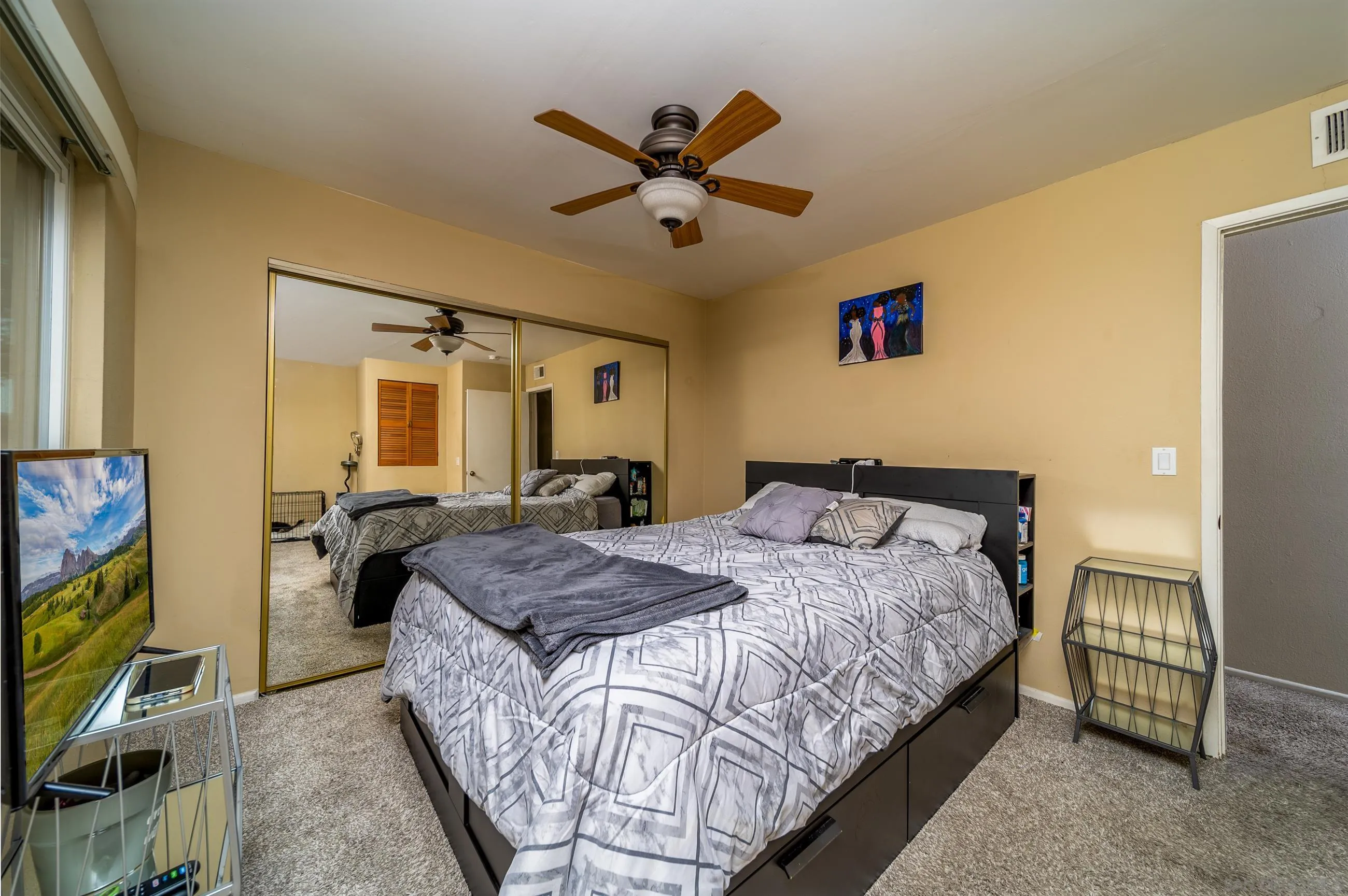9920 Mission Vega Road, Unit 2 Santee, CA 92071 - Photo 10 of 21 a bedroom with a bed and a flat screen tv
