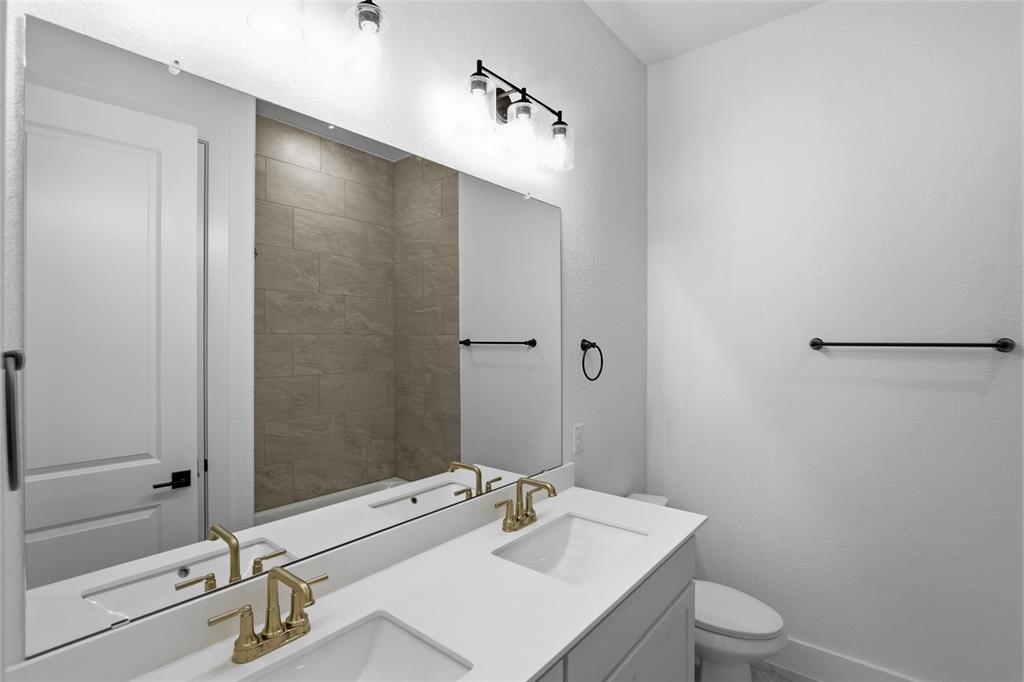 810 Vly Rdg Road Van Alstyne, TX 75495 - Photo 26 of 39 Full bathroom featuring double vanity and toilet