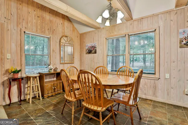 a view of a dining room with furniture and a large window