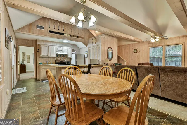 a view of a a dining room with furniture window and wooden floor