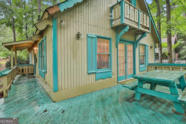a backyard of a house with table and chairs
