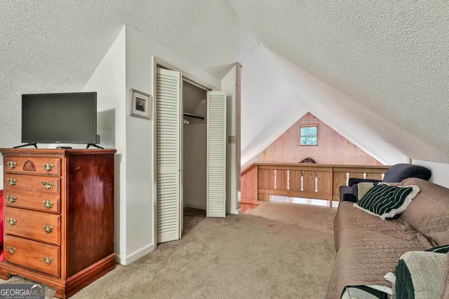 a bedroom with a bed and a television