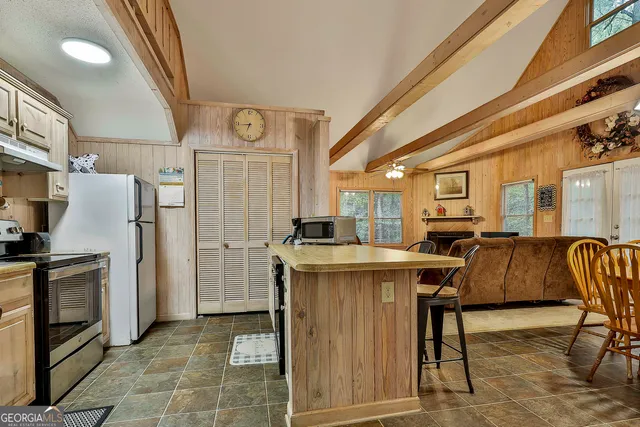 a kitchen with stainless steel appliances granite countertop a refrigerator and a stove top oven
