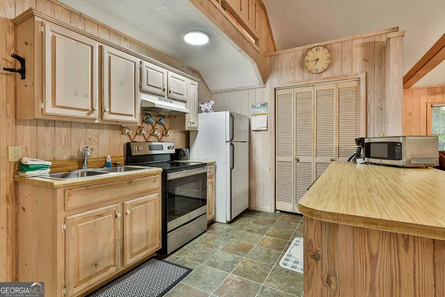 a kitchen with cabinets and stainless steel appliances
