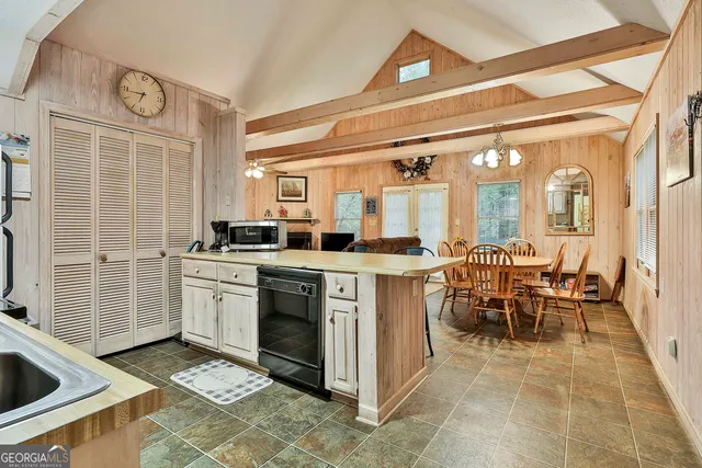 a kitchen with sink cabinets and stove top oven