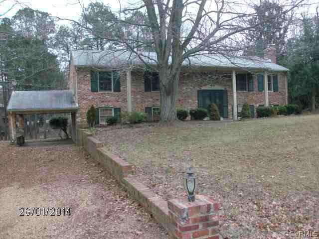 13011 Buckland Road Chester, VA 23831 - Photo 1 of 13 a view of a house with a yard and large tree