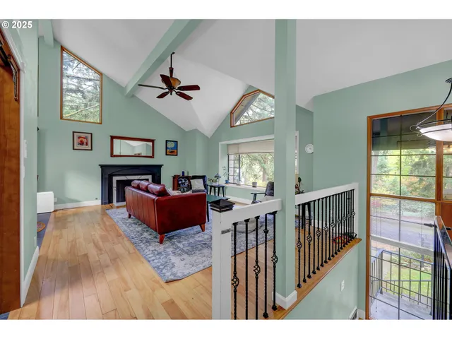 a living room with fireplace furniture and a wooden floor