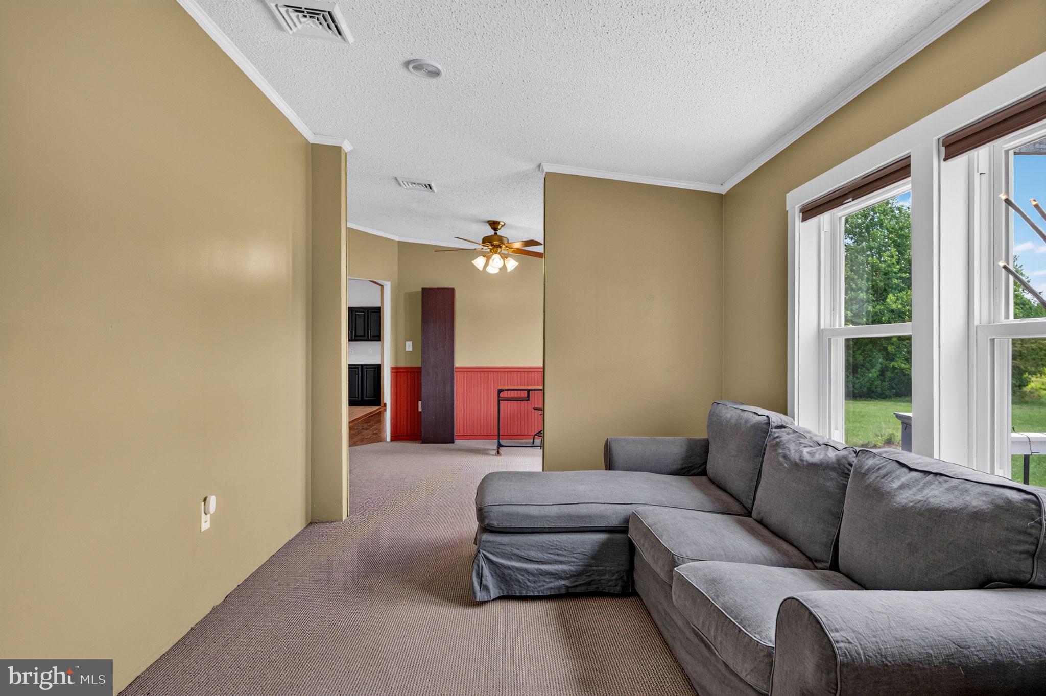 106 Quinton Alloway Road Salem, NJ 08079 - Photo 8 of 63 a living room with furniture and a large window