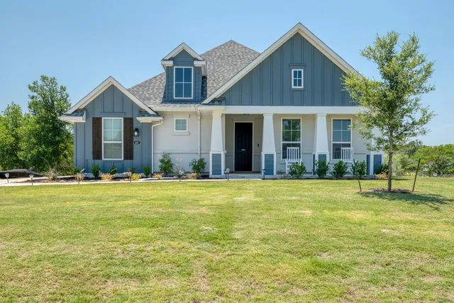 a front view of the house with yard and green space