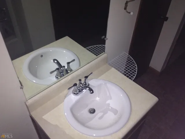 a bathroom with a sink and mirror