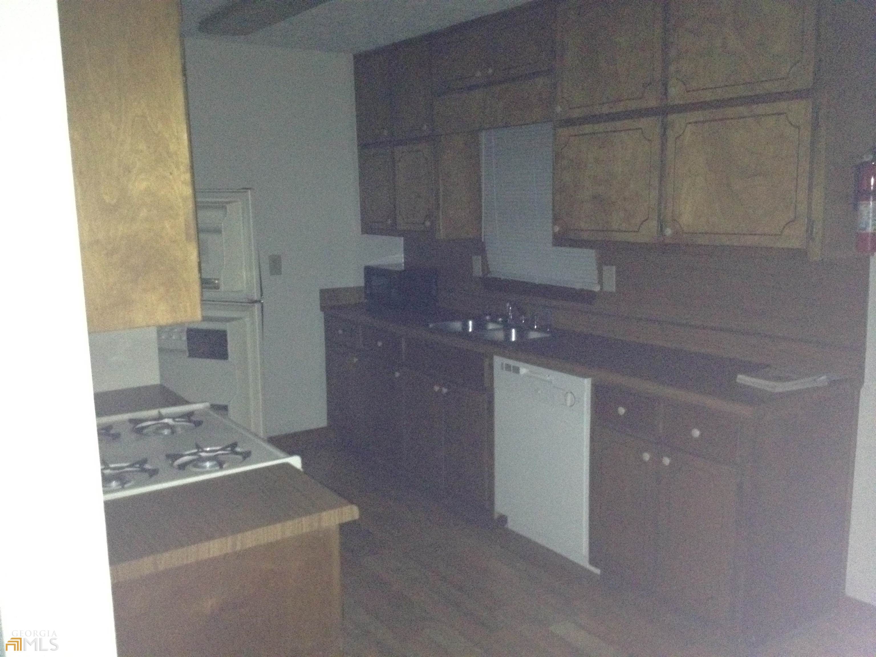 103 Appleton Boulevard Stockbridge, GA 30281 - Photo 22 of 31 a kitchen with a sink stove and cabinets