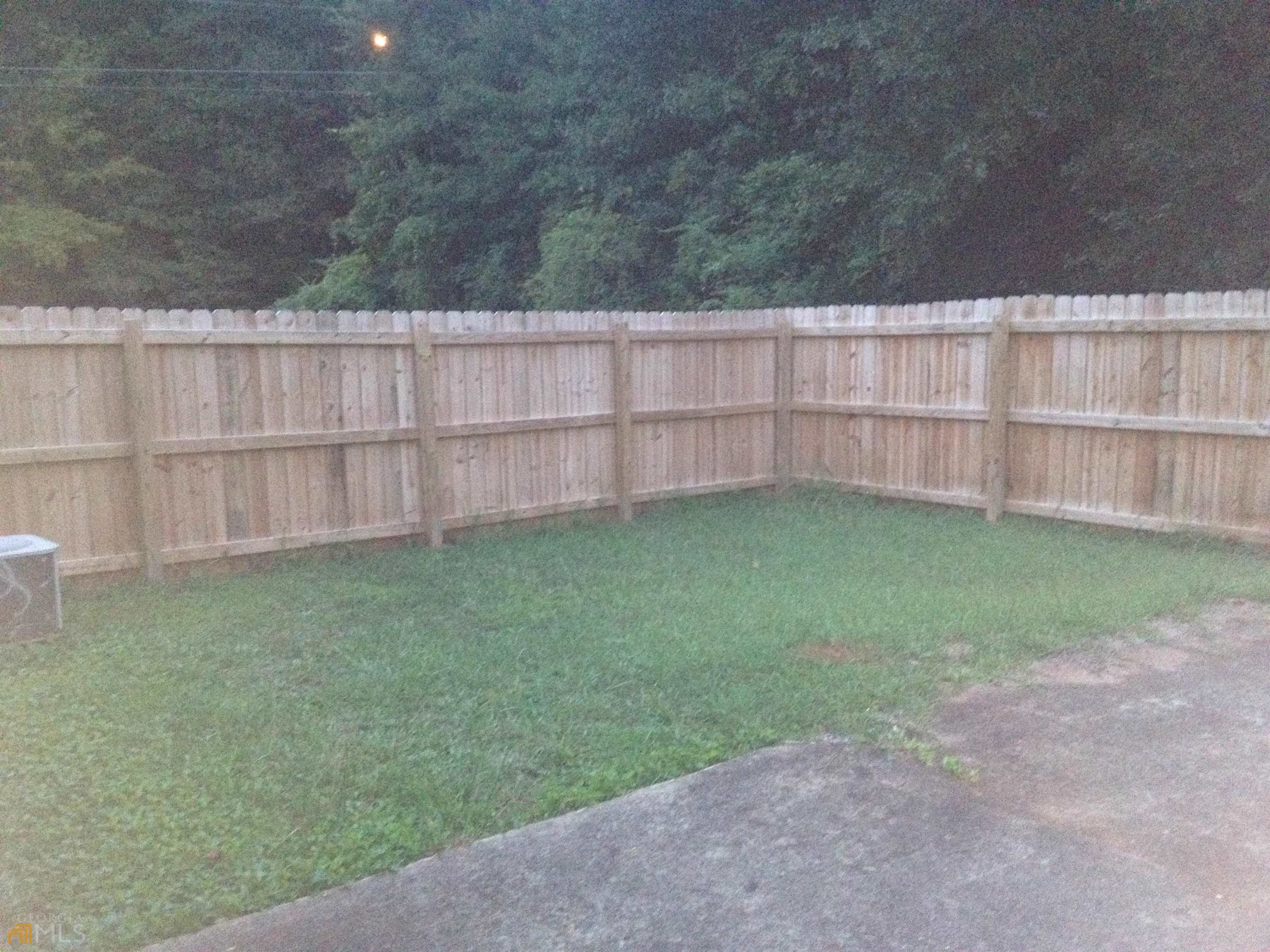 103 Appleton Boulevard Stockbridge, GA 30281 - Photo 3 of 31 a view of a backyard with a wooden fence