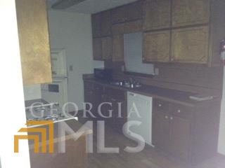 103 Appleton Boulevard Stockbridge, GA 30281 - Photo 5 of 31 a kitchen with a sink and cabinets
