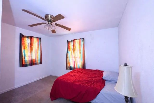 a bed room with a bed and a window