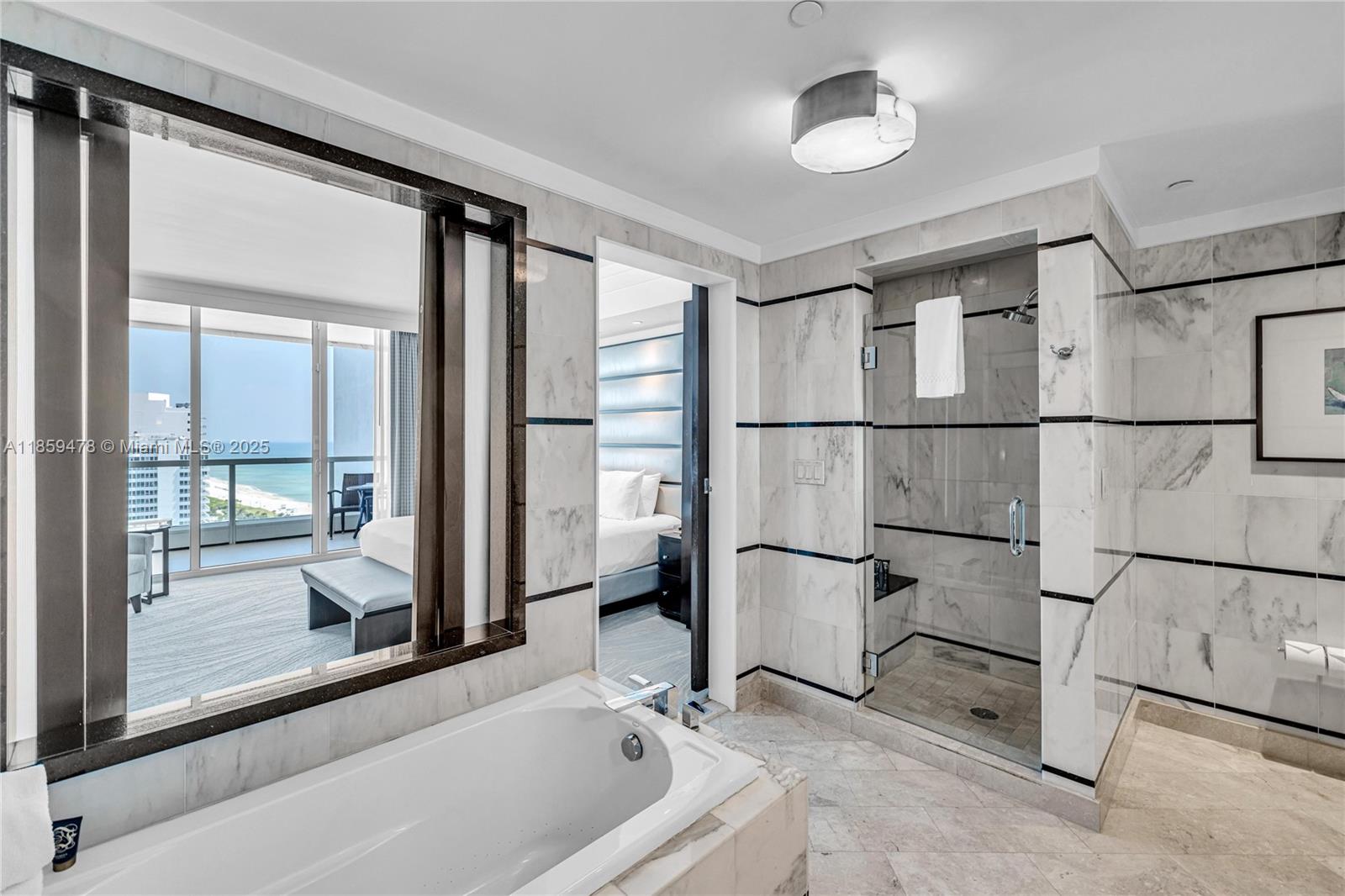 4391 Collins Avenue, Unit 1706/1707 Miami Beach, FL 33140 - Photo 18 of 50 a view of entryway with dining room and chandelier