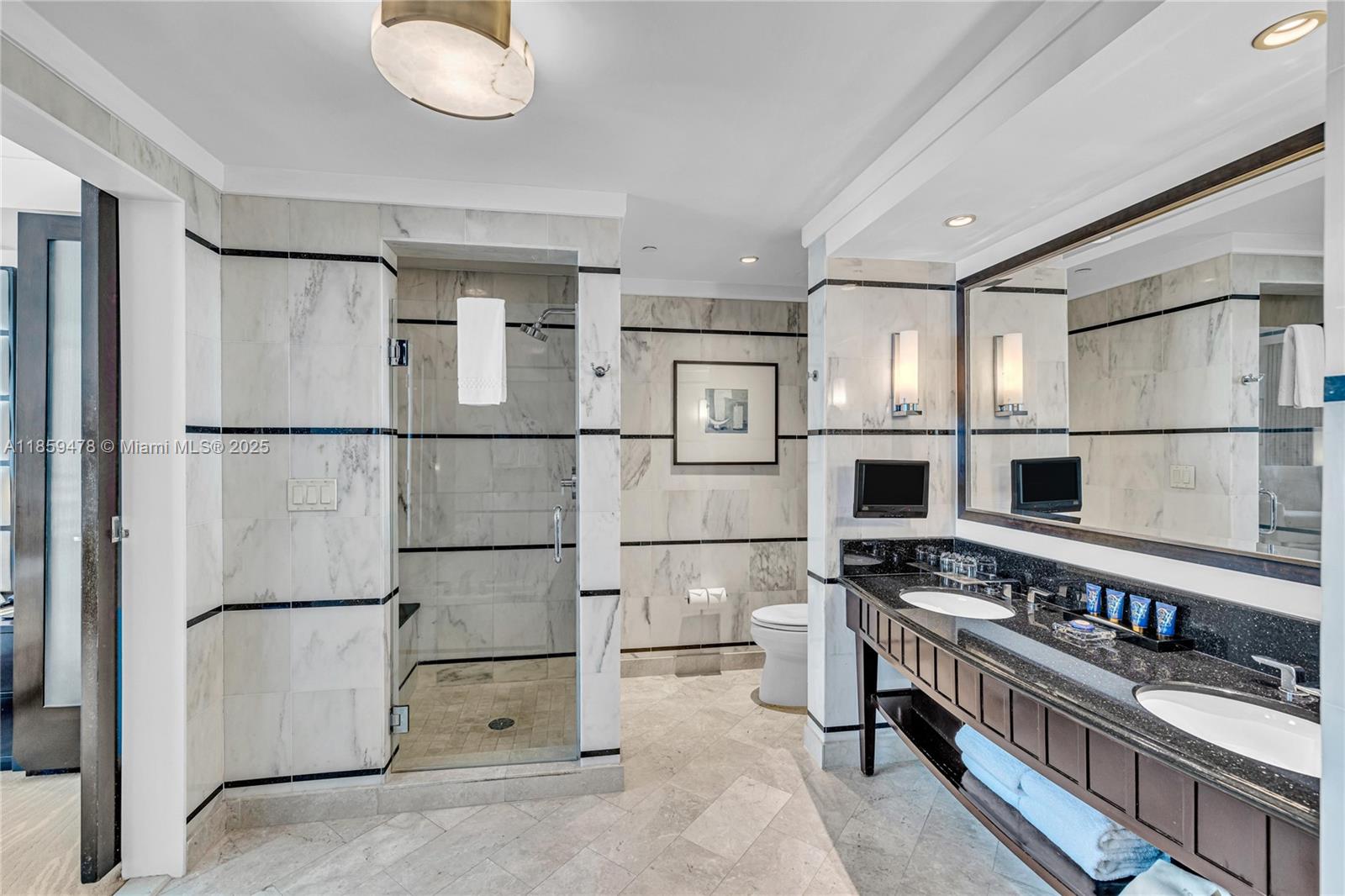 4391 Collins Avenue, Unit 1706/1707 Miami Beach, FL 33140 - Photo 19 of 50 a kitchen with stainless steel appliances refrigerator and cabinets
