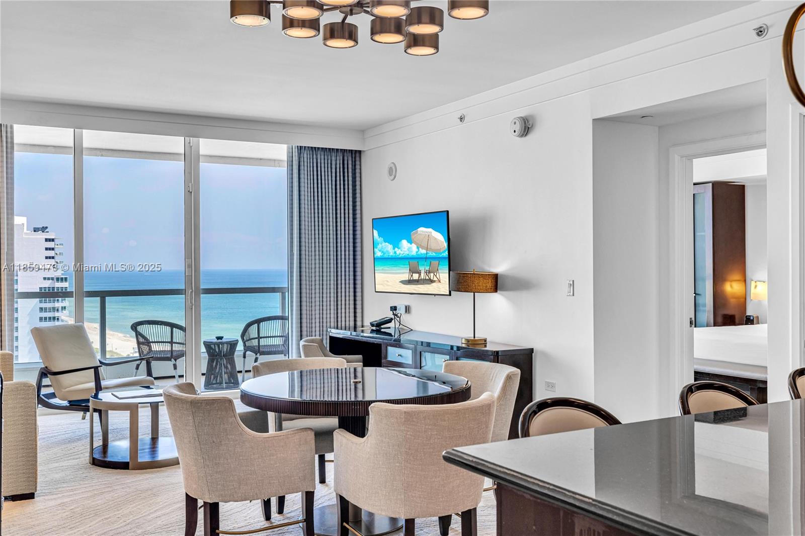 4391 Collins Avenue, Unit 1706/1707 Miami Beach, FL 33140 - Photo 2 of 50 a dining room with furniture and a large window