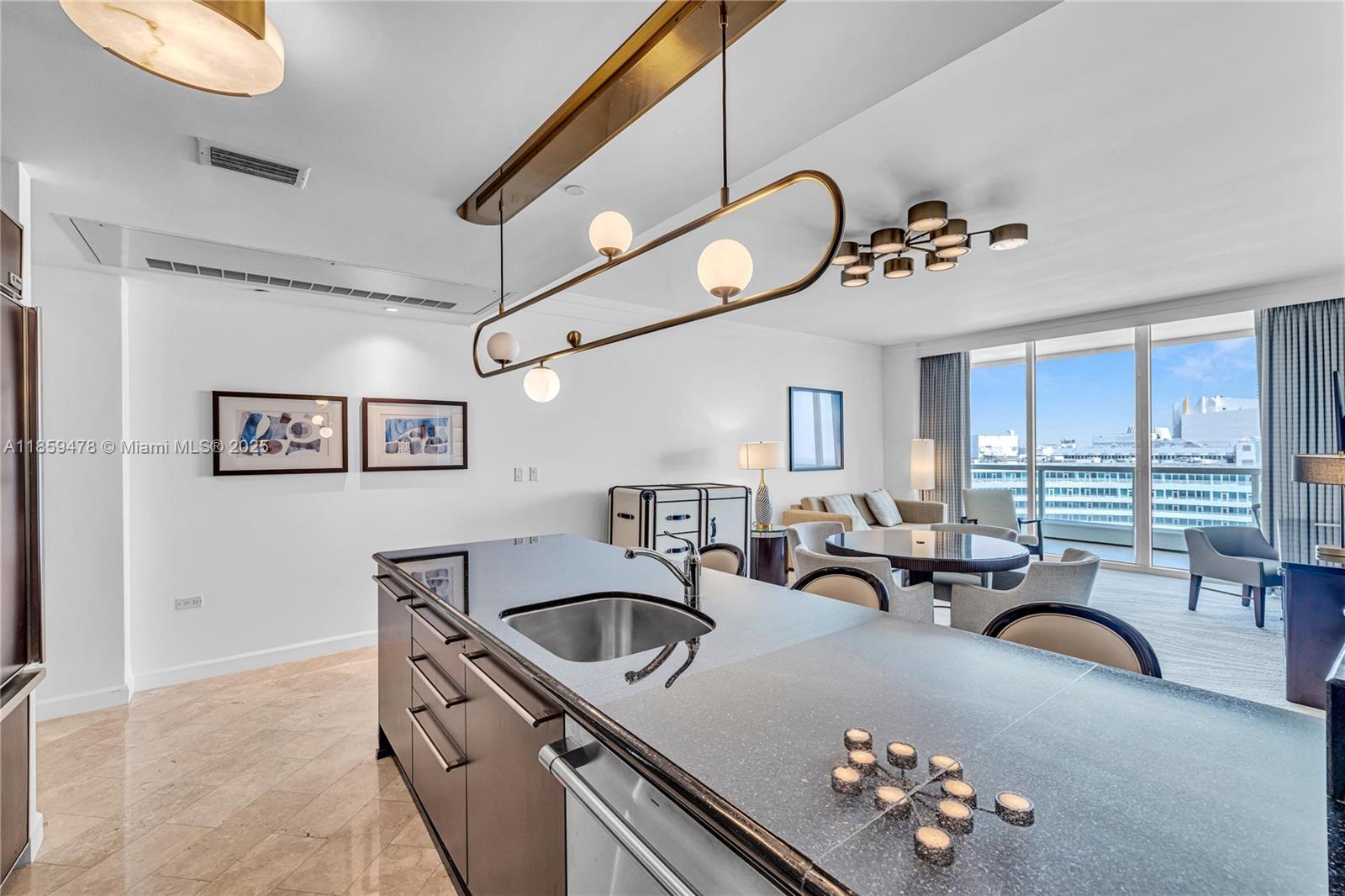 4391 Collins Avenue, Unit 1706/1707 Miami Beach, FL 33140 - Photo 22 of 50 a kitchen with furniture a chandelier and a sink