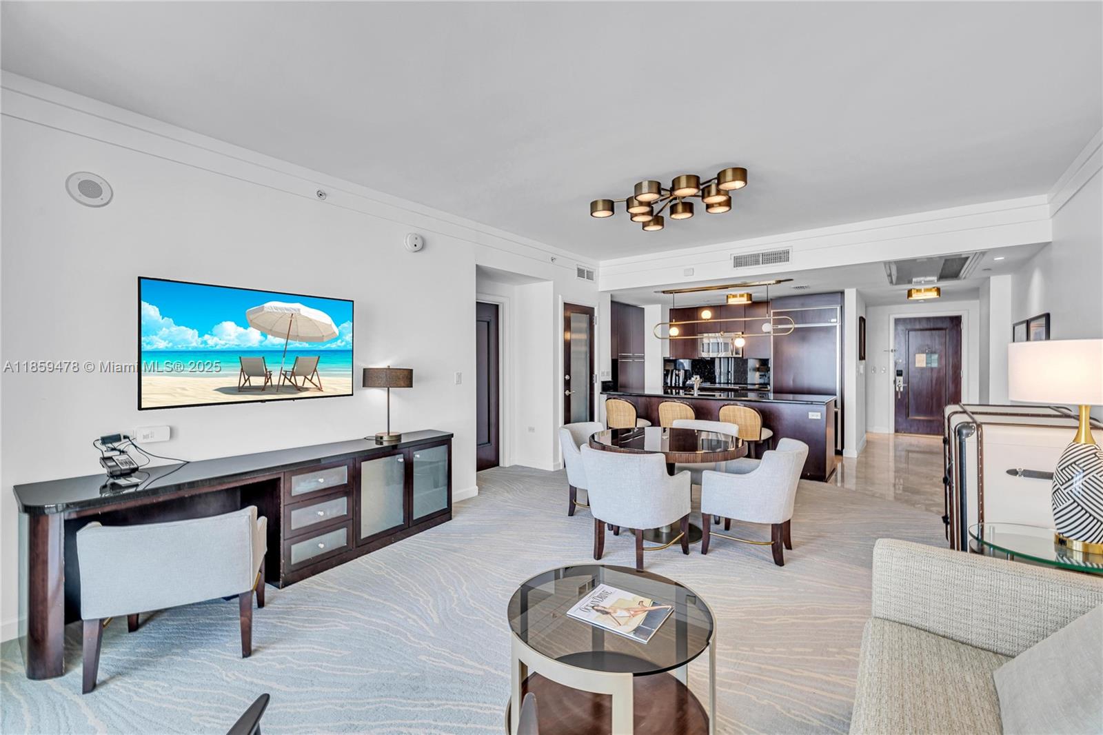 4391 Collins Avenue, Unit 1706/1707 Miami Beach, FL 33140 - Photo 24 of 50 a living room with furniture and a flat screen tv