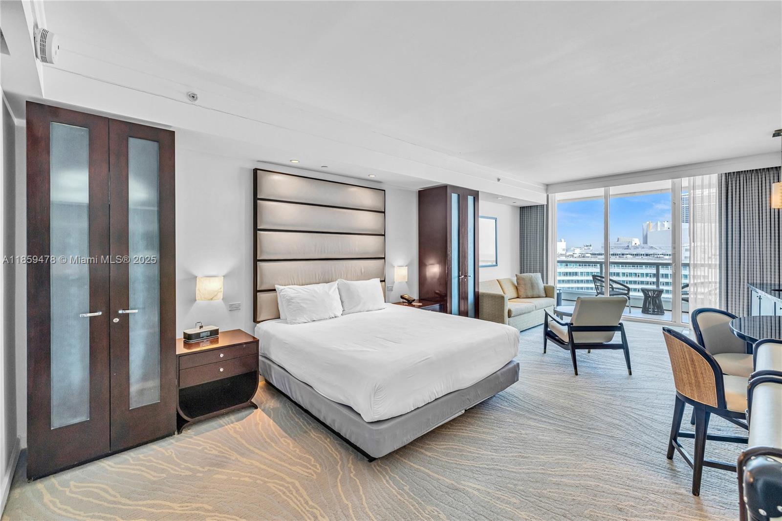 4391 Collins Avenue, Unit 1706/1707 Miami Beach, FL 33140 - Photo 28 of 50 a bedroom with a bed and a large window