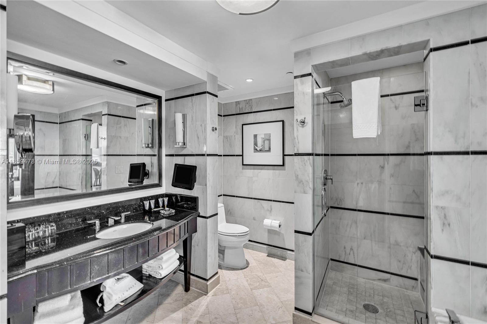 4391 Collins Avenue, Unit 1706/1707 Miami Beach, FL 33140 - Photo 34 of 50 a kitchen with stainless steel appliances a refrigerator and a stove top oven