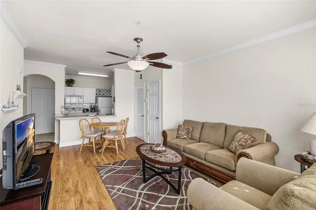 a living room with furniture a dining table and a fireplace