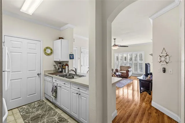 a kitchen with a refrigerator and a stove top oven