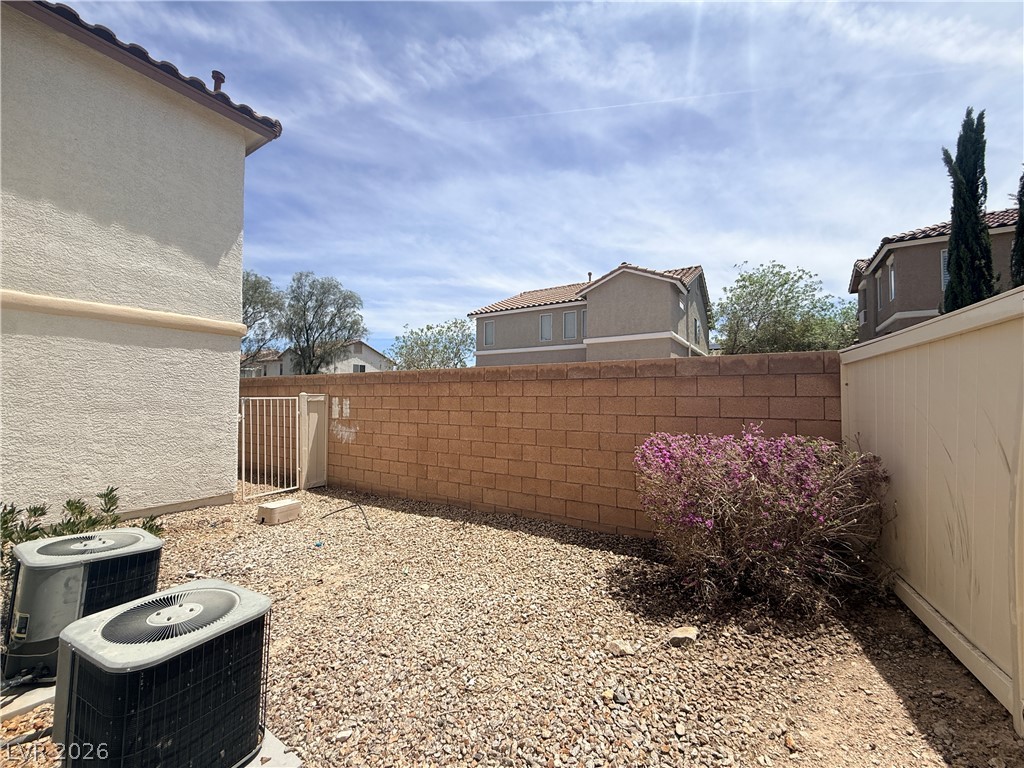 11953 Fairfax Ridge Street Las Vegas, NV 89183 - Photo 31 of 32 A private xeriscape backyard features durable block walls and low-maintenance landscaping.