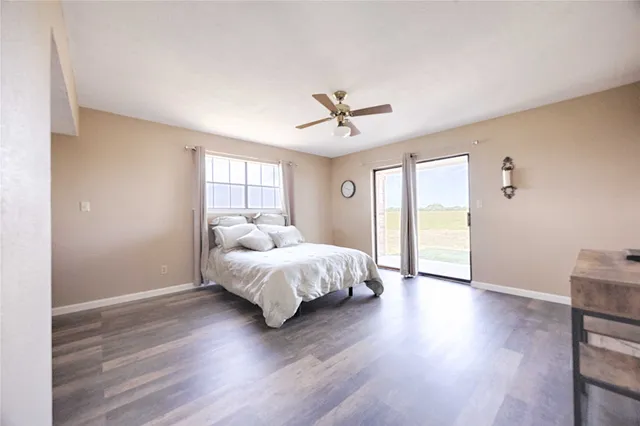 a bedroom with a bed lamp closet and windows