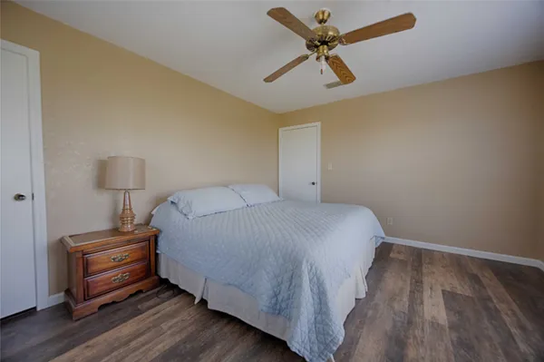 a bathroom with a granite countertop sink a mirror and a shower