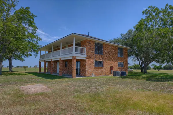a front view of house with yard and trees