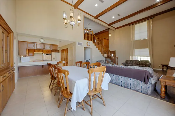 a view of a dining room with furniture and chandelier
