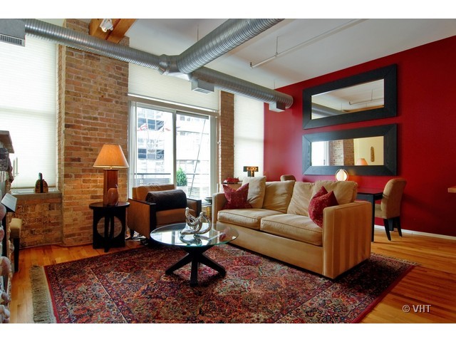 417 South Jefferson Street, Unit 202B Chicago, IL 60607 - Photo 6 of 8 a living room with furniture a table and a large window