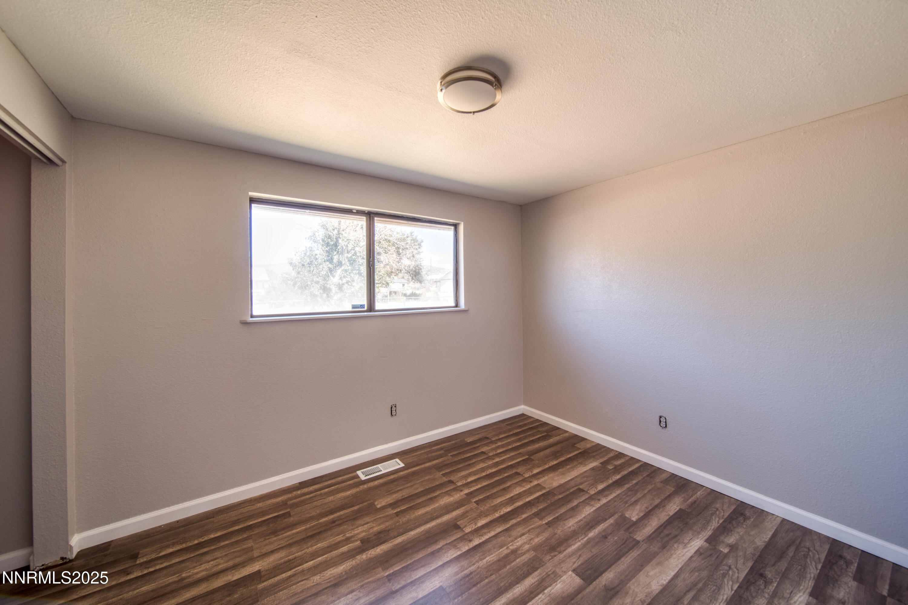 11590 Tupelo Street Reno, NV 89506 - Photo 16 of 19 a view of a room with wooden floor and windows