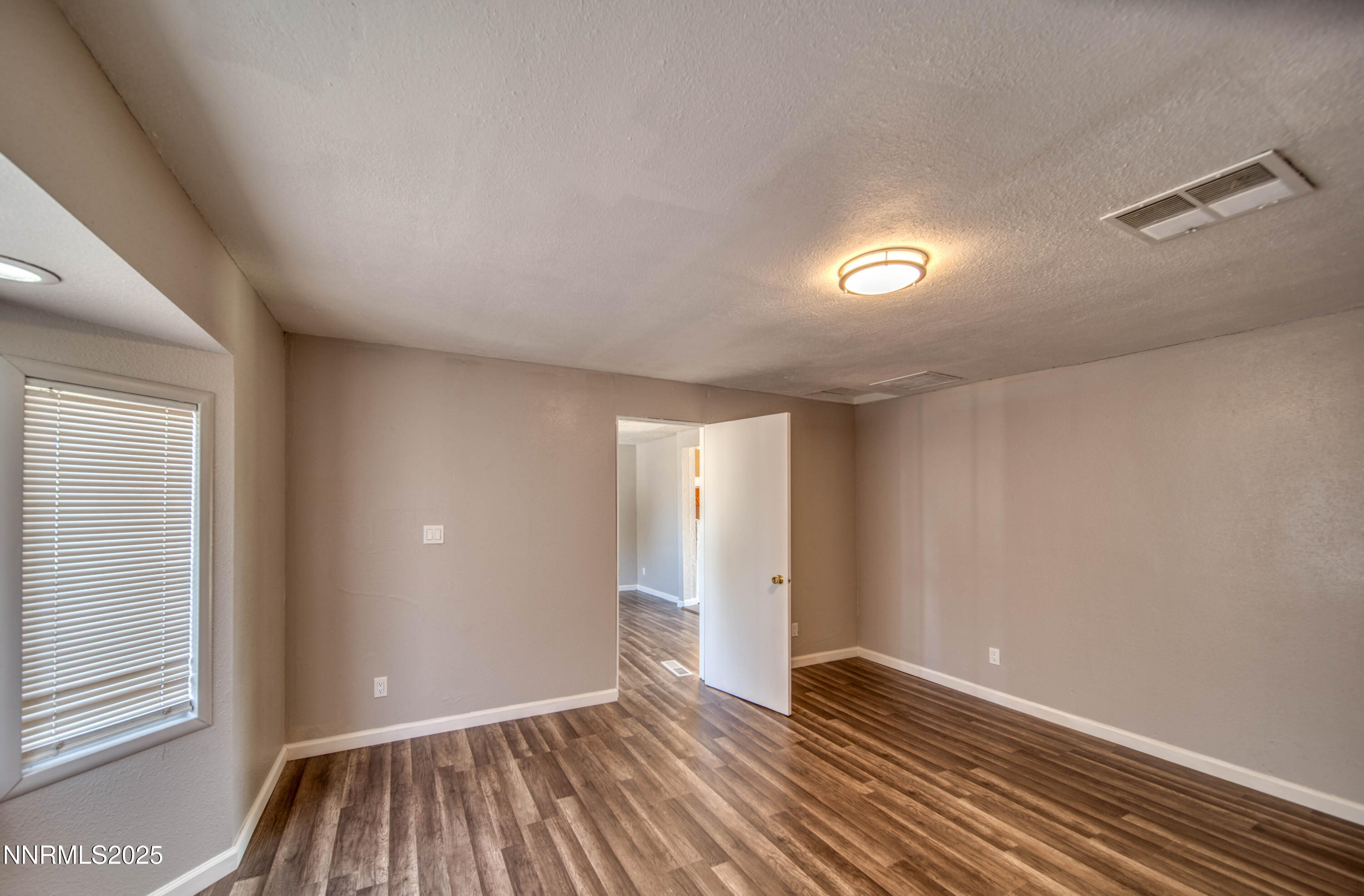 11590 Tupelo Street Reno, NV 89506 - Photo 6 of 19 wooden floor in an empty room with a window