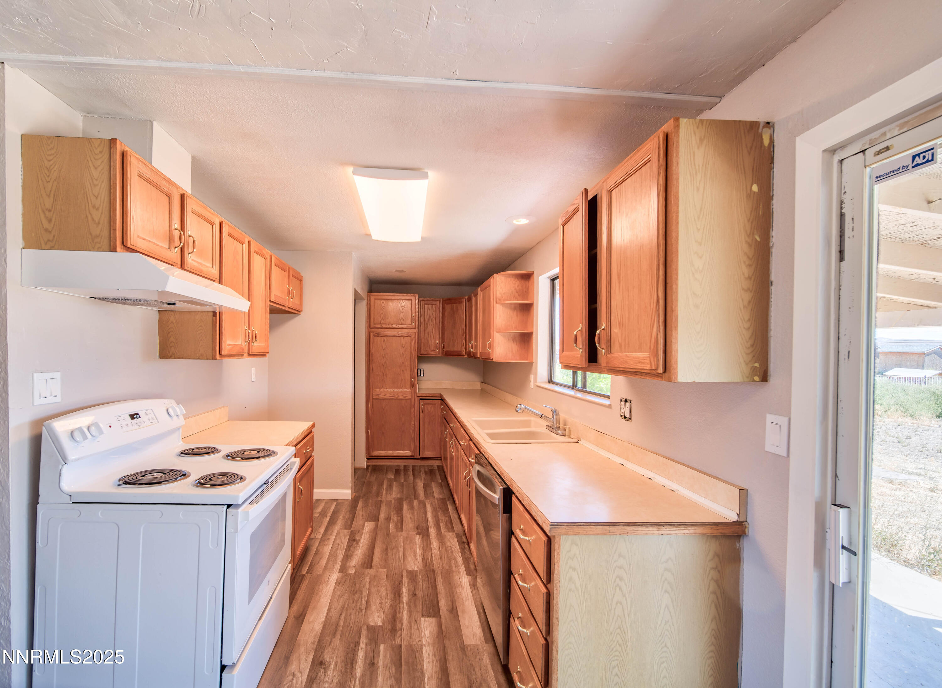 11590 Tupelo Street Reno, NV 89506 - Photo 8 of 19 a kitchen with a sink a stove and a refrigerator