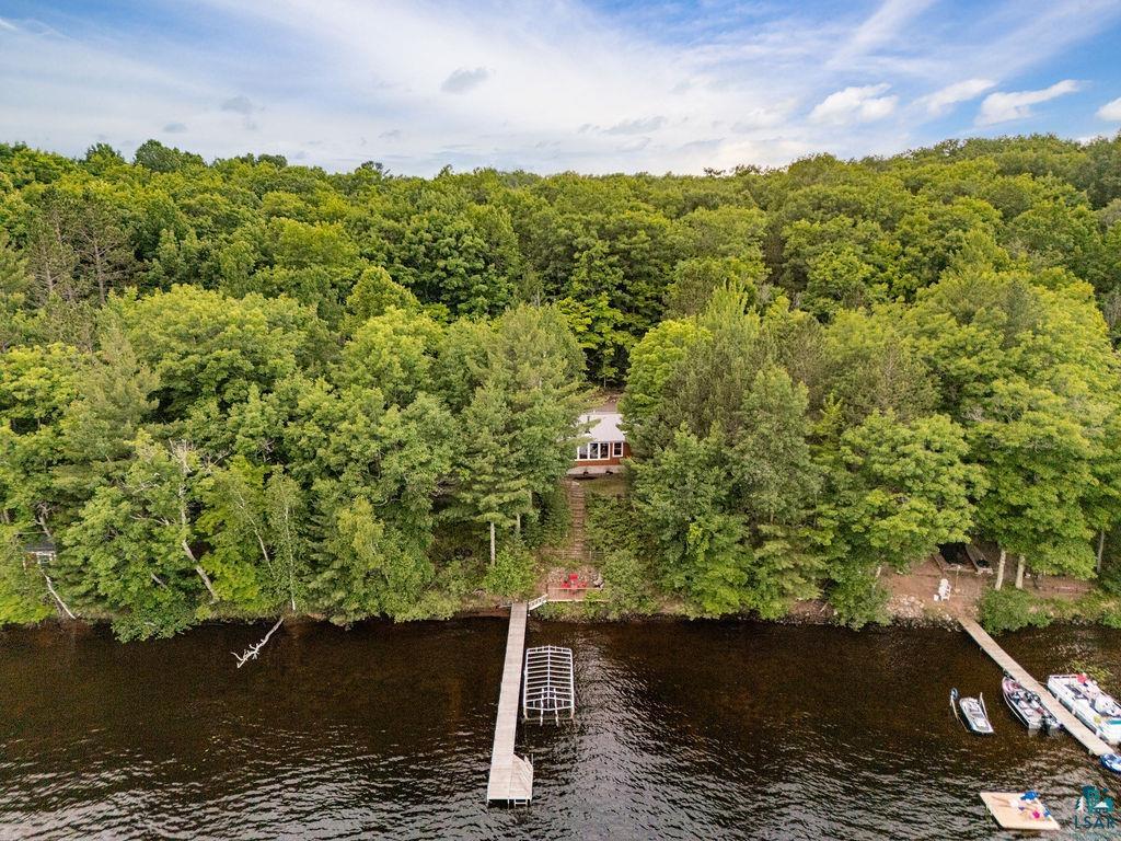 7338 South Maranatha Road Lake Nebagamon, WI 54849 - Photo 13 of 41 Waterfront property featuring a private dock, forested surroundings, and a secluded home