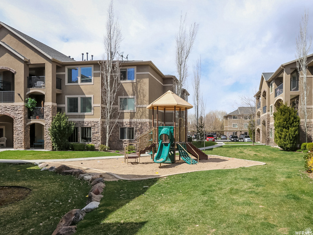 909 South Main Street, Unit F Layton, UT 84041 - Photo 9 of 20 Community green space featuring a playground with slides and a sand area